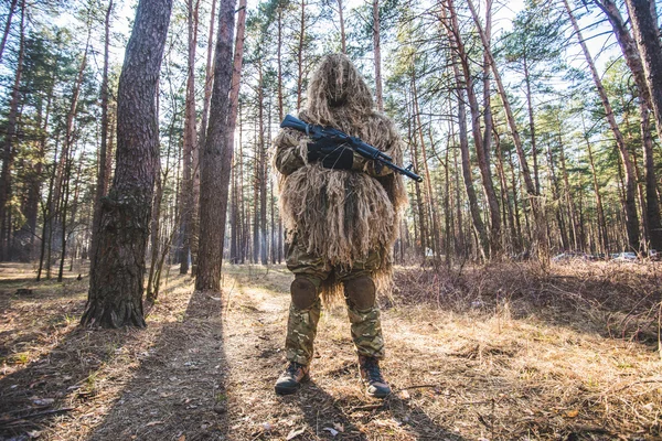 Camouflaged Hunter In Jungle Like Area With Sniper Rifle , He Must Blend  Into Surrounding To Not Be Detected Stock Photo, Picture and Royalty Free  Image. Image 67250301.