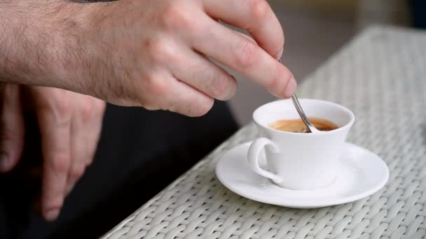 Man stirs his coffee — Stock Video