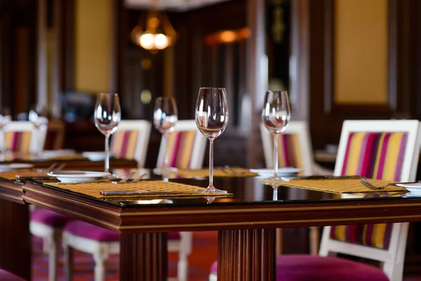 Wine glasses on a dining table in a restaurant — Stok fotoğraf