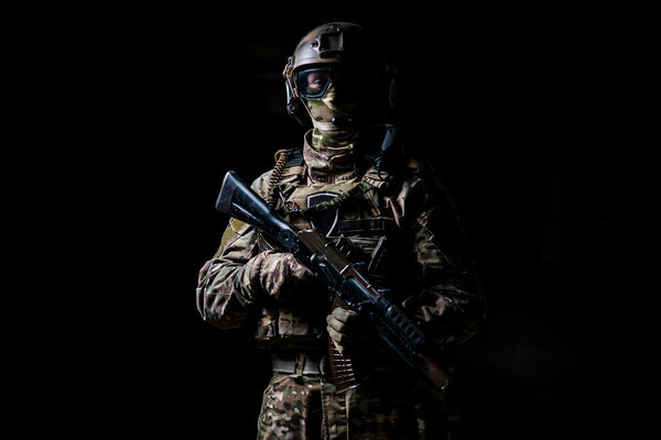 Military man in a mask and with a submachine gun