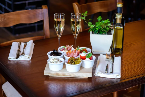 Italian aperitif from a variety of snacks on a table for date — Stock Photo, Image