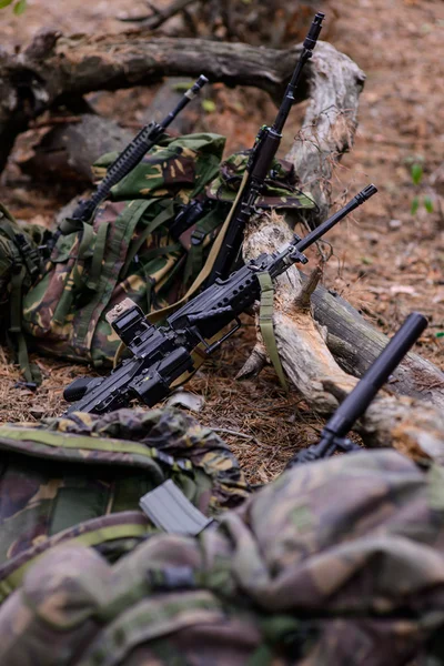 Camouflaged sniper lying in forest and aiming through his scope Stock Photo  by ©Nesterenko_Max 89112398