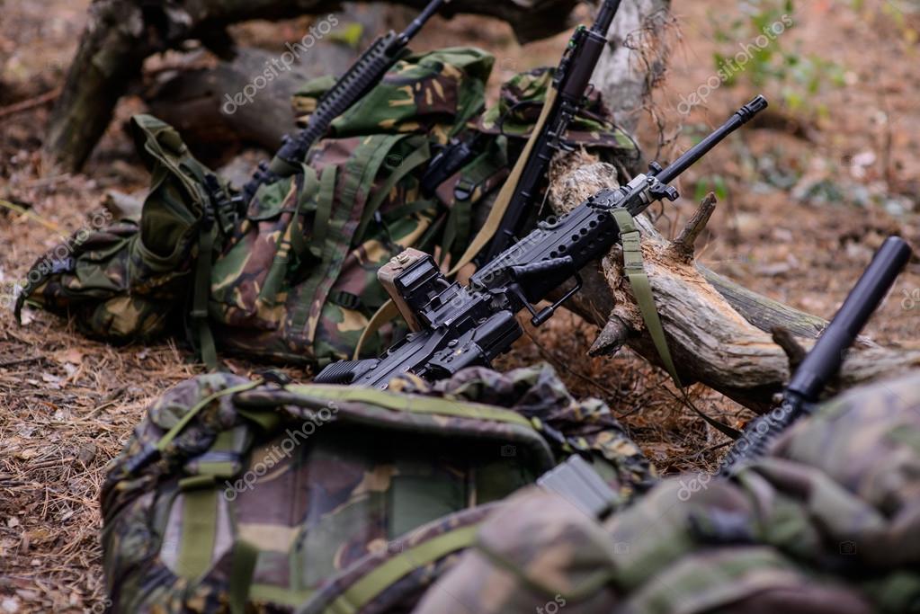 Machine gun and assault rifle on ground Stock Photo by ©Nesterenko_Max 87481472