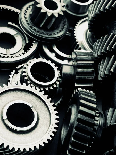 Blue tint black industrial gears and cogs on black background, banner