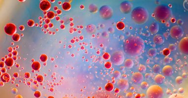 Renkli arkaplan ile su yüzeyine yağ damlaları