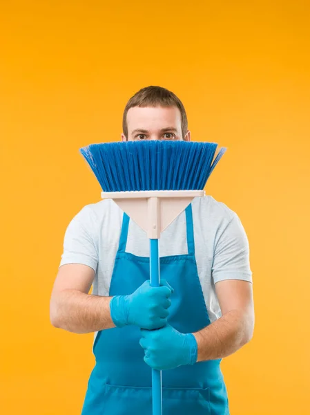Caucasian Male Cleaner Hides Broom Surprised Expression Yellow Background — Stock Photo, Image