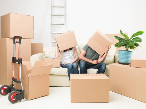 Couple Sitting Sofa Boxes Heads New House — Stock Photo, Image