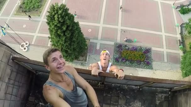 Chicos jóvenes realizan acrobacias en el edificio de gran altura . — Vídeo de stock