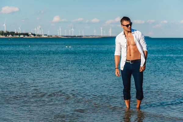 Man walking on the beach Royalty Free Stock Images