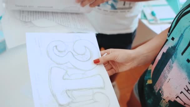 Diseñadoras de moda femenina dibujando bocetos para la ropa en el taller. Secuencia — Vídeo de stock