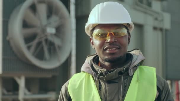 Afrikansk ingenjör står emot elstationsfläkt — Stockvideo