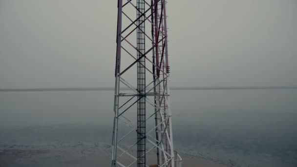 Motion up along contemporary cell tower on coastal area — Stock Video