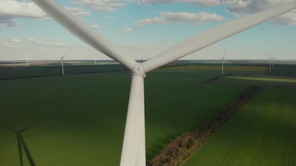 Obrotowe ostrze maszyny wiatrowej na zielonym polu latem — Wideo stockowe