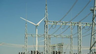 High voltage substation at wind driven plant under blue sky