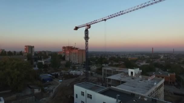 Turmdrehkran bei Sonnenuntergang. Abflug Quadrokopter. Luftaufnahmen. — Stockvideo