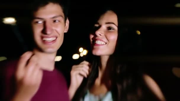 Een jonge man en vrouw plezier in de nacht ontstoken wonderkaarsen — Stockvideo