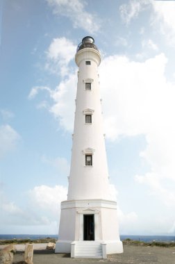 Aruba Nautical lighthouse to guide boats. Aruban lighthouse, white beach lighthouse, light house along the water, beach aesthetic, white lighthouse, beach lighthouse. 