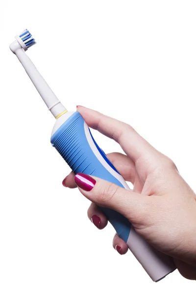 Hand with manicure holds single blue electric toothbrush — Stock Photo, Image