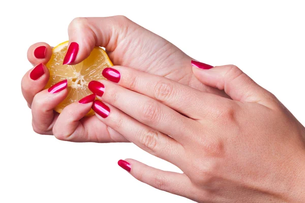 Manicured nails painted a deep red caress dark pink flower Stock Picture