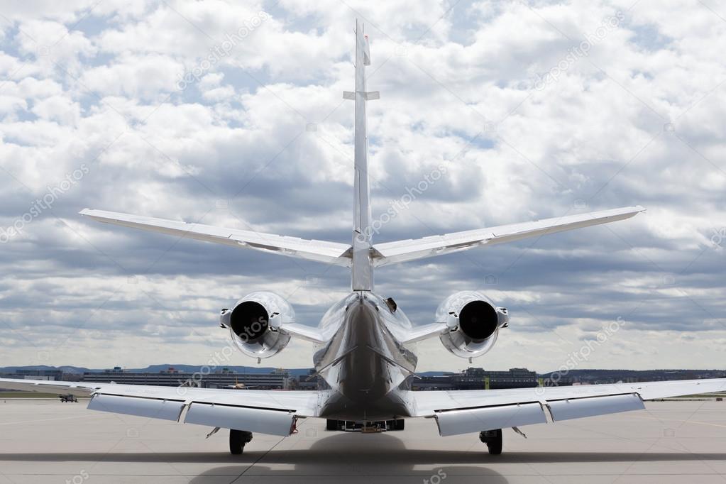 Aircraft learjet Plane in front of the Airport with cloudy sky