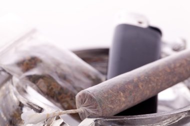 Close up of marijuana and smoking paraphernalia clipart
