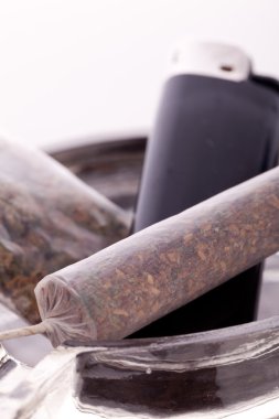 Close up of marijuana and smoking paraphernalia clipart