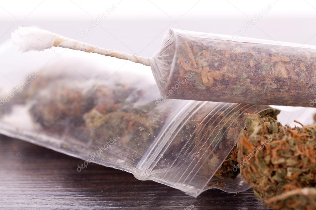 Close up of dried marijuana leaves and joint