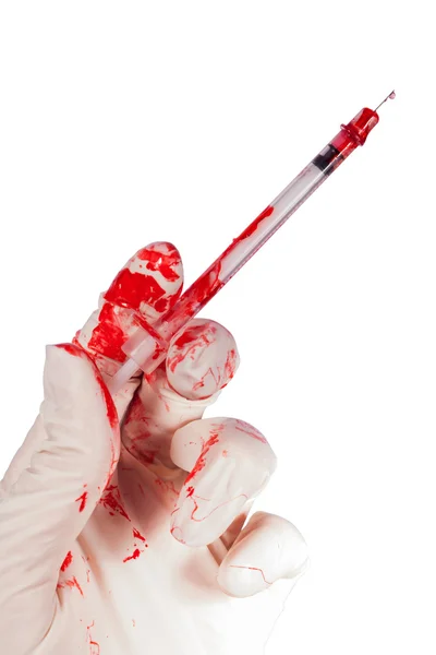 Bloody gloved hand holding a syringe — Stock Photo, Image