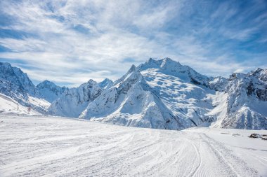 Kayak pisti, Peak Ine ve Mount. Kışın güneşli bir günde Sofrudzhu. Dombay kayak merkezi, Batı Kafkasya, Rusya.