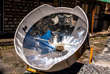 Solar cooker in the Himalaya mountains. clipart
