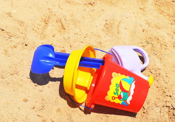 Children plastic toys on the sand — Stock Photo, Image