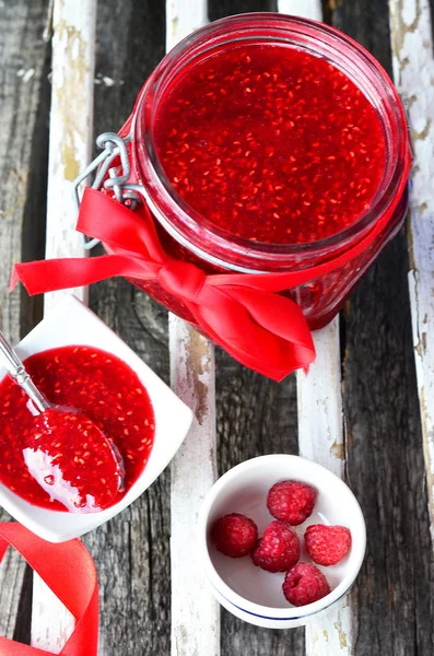 Raspberry jam in the jar on the striped board — Stock Photo, Image