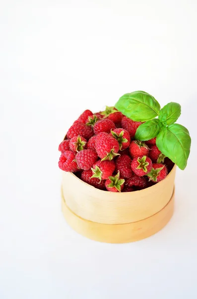 Raspberry in the round box with leaf of mint on the white background — Stock Photo, Image