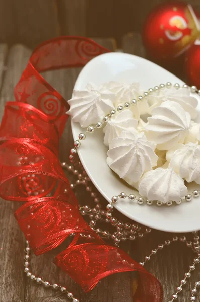 Christmas still life with plate of meringue, Happy New Year decoration, selective focus, toned photo — Stock Photo, Image