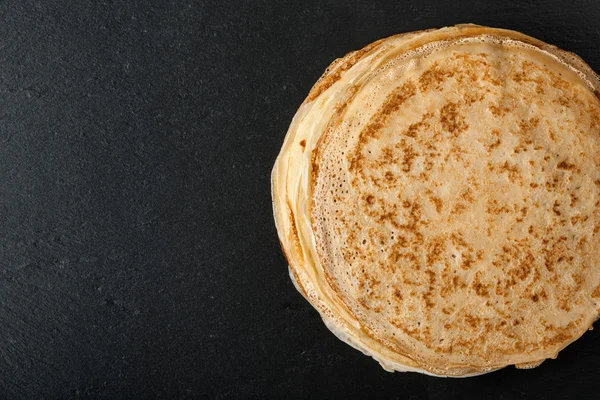 Stack of pancakes on black — Stock Photo, Image