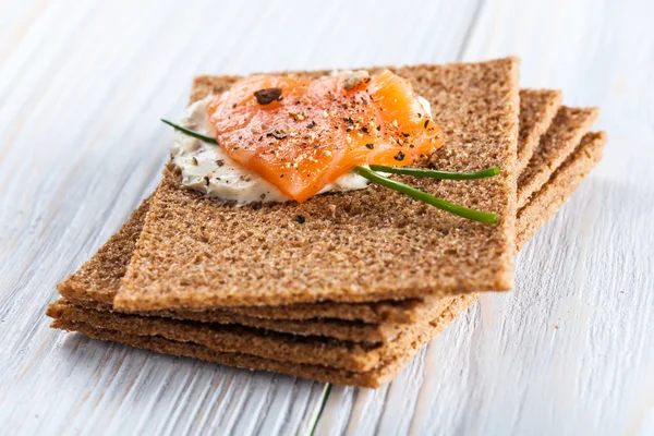 Canape with smoked salmon and crackers — Stock Photo, Image