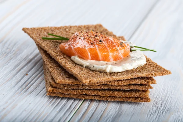 Canape with smoked salmon and crackers — Stock Photo, Image