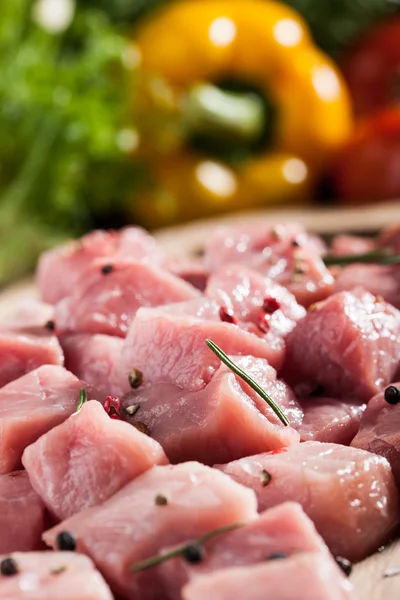 Raw pork  on cutting board and fresh vegetables — Stock Photo, Image