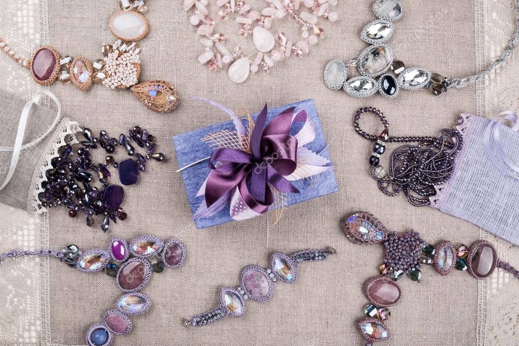 Female jewelry and gift box on linen tablecloth Stock Photo by ©ffphoto