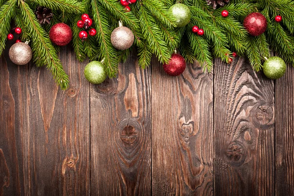 Fir tree decorated balls on dark wooden background Stock Image
