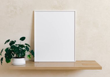 Tekli 8x10 dikey beyaz çerçeve modeli vazoda yeşil bitki ve ahşap raf ve bej duvar. Ahşap rafta yeşil bitki ve bej arkaplanlı boş bir poster modeli. 3B Hazırlama
