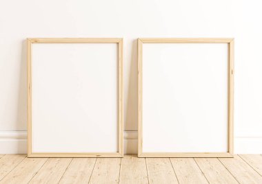 Ahşap zemin ve beyaz duvarda çift 8x10 dikey ahşap çerçeve modeli. Ahşap zeminde iki boş poster modeli ve beyaz arka plan. 3B Hazırlama