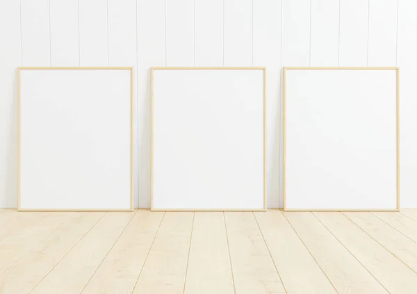 Triple 8x10 Vertical wooden Frame mockup on wooden floor and white wood wall. Three empty poster frame mockup on wooden floor and white wood background. 3D Rendering