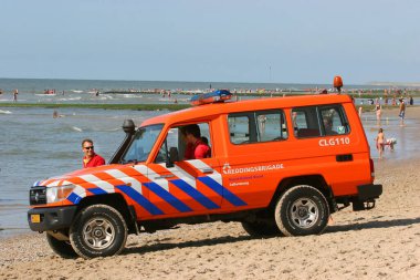 Kamu plajında işçileri olan kurtarma ekibi arabası, seyahat çekimi.
