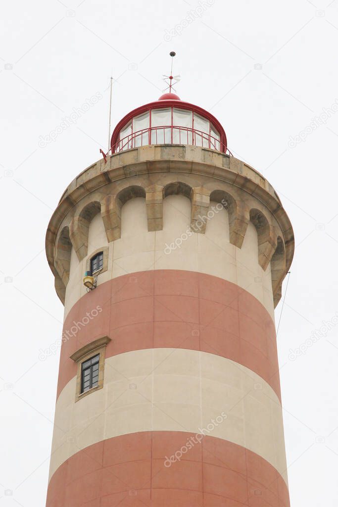 red and white painted lighthouse in coastal city center