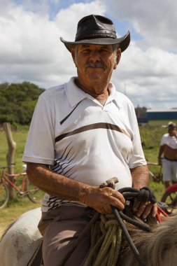 At üstünde şapka takan son sınıf öğrencisi.