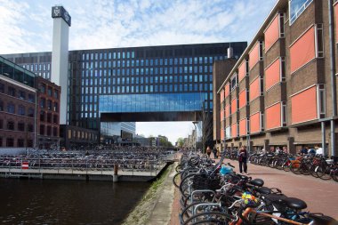 Amsterdam, Hollanda, 15 Temmuz 2018: Su kanalının kenarına parketmiş bisikletler