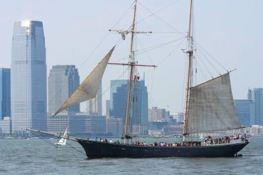 Arka planda New Jersey gökdelenleri olan turistli bir yelkenli.