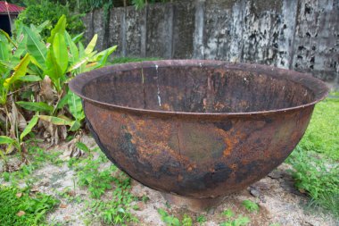 Bahçedeki paslı metal havan topu.