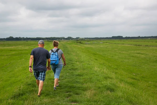 Doğada çimenlerde yürüyen bir çift.